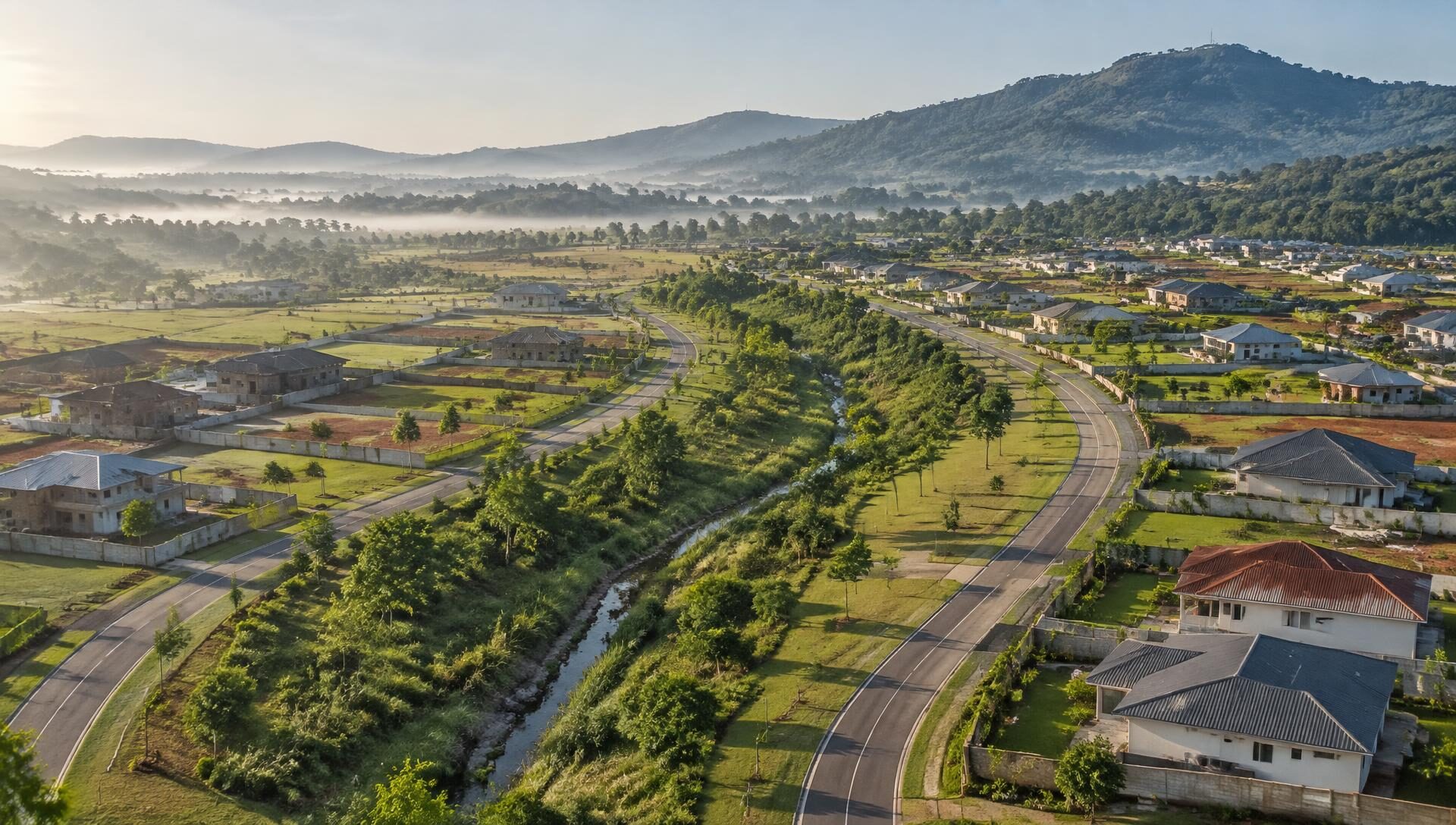 Aerial view of a planned East African growth centre with a green tree corridor